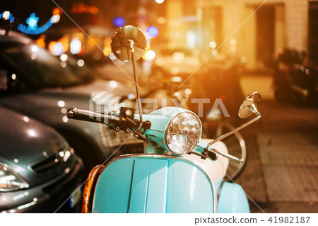 Light blue retro scooter on the street Light blue retro scooter on the street 41982187