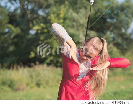 Teen Majorette Girl Twirling Baton Outdoors Teen Majorette Girl Twirling Baton Outdoors 41984562