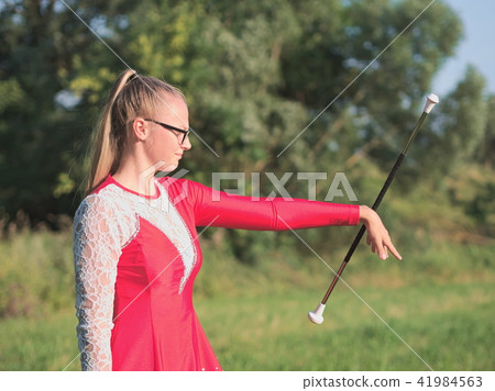 Teen Majorette Girl Twirling Baton Outdoors Teen Majorette Girl Twirling Baton Outdoors 41984563