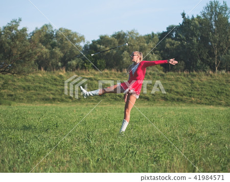 Teen Majorette Girl Twirling Baton Outdoors Teen Majorette Girl Twirling Baton Outdoors 41984571