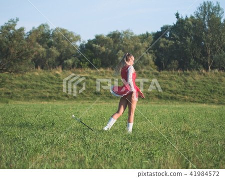Teen Majorette Girl Twirling Baton Outdoors Teen Majorette Girl Twirling Baton Outdoors 41984572