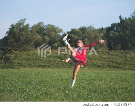 Teen Majorette Girl Twirling Baton Outdoors Teen Majorette Girl Twirling Baton Outdoors 41984574