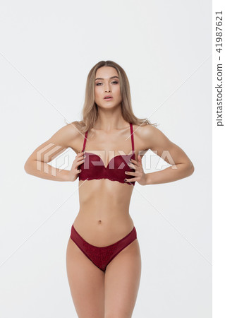 Hot woman in red lingerie touching breast Hot woman in red lingerie touching breast 41987621