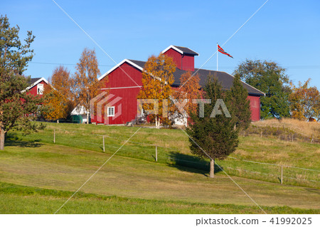 Norwegian landscape with red wooden barn 41992025