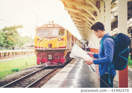 Tourist backpacker using map to travel Tourist backpacker using map to travel 41992478