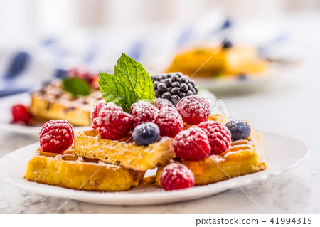 Fresh waffles with berries sugar powder  and mint. 41994315