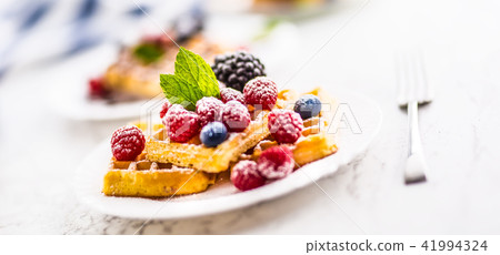 Fresh waffles with berries sugar powder and mint. 41994324