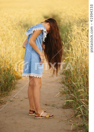 young girl in the yellow field 41994338