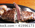 Lifting the sirloin steak 41996173
