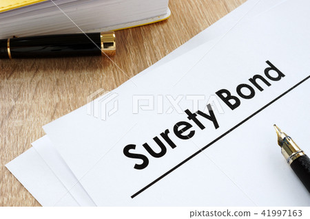 Surety bond form and pen on a table. Surety bond form and pen on a table. 41997163