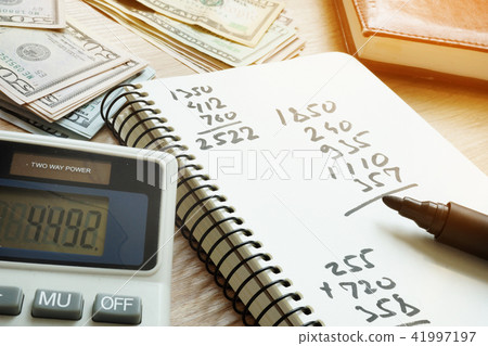 Calculator and notepad with calculations. Calculator and notepad with calculations. 41997197