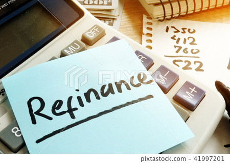 Refinance written on a memo stick and calculator. Refinance written on a memo stick and calculator. 41997201