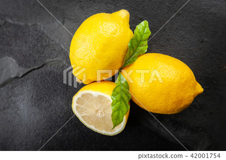 Fresh lemons with green leaves Fresh lemons with green leaves 42001754