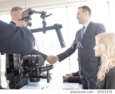 Videographer making video of business people Videographer making video of business people 42001976