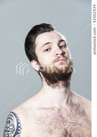 sexy inked hairy young man with tattoo and beard 42002934