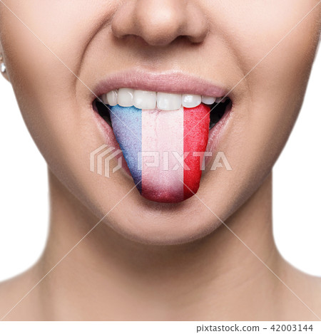 Young woman showing tongue with france flag. 42003144