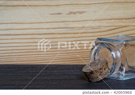 Jar with cork on wooden table 42003968