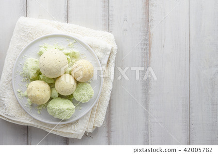 Handmade mint bath bombs and towel on white planks Handmade mint bath bombs and towel on white planks 42005782