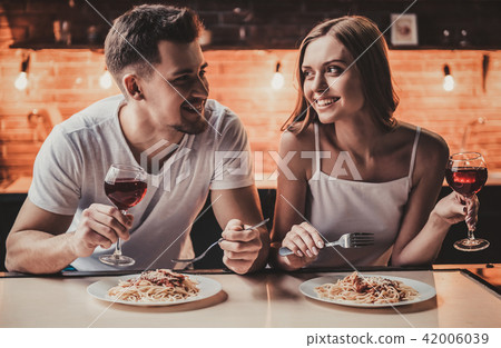 Smiling Young Couple Have Dinner and Drink Wine. 42006039