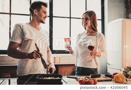 Young Couple Cooking Dinner and Drink Red Wine. 42006045