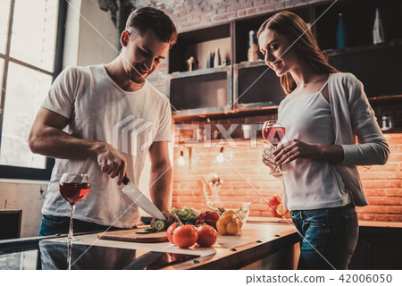 Young Couple Cooking Dinner and Drink Red Wine. Young Couple Cooking Dinner and Drink Red Wine. 42006050