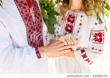 Beautiful couple in national Ukrainian shirts Beautiful couple in national Ukrainian shirts 42006156