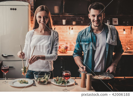 Young Couple Cooking Dinner and Drink Red Wine. Young Couple Cooking Dinner and Drink Red Wine. 42006188