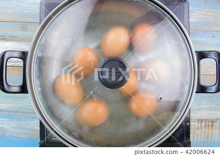 chef cooking boiled eggs in pot 42006624