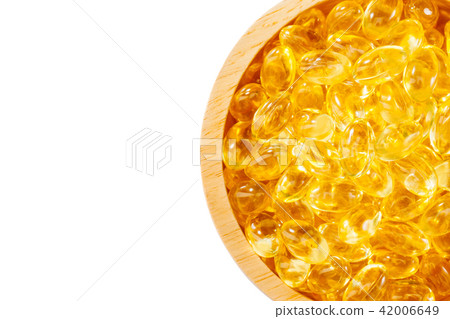 Fish oil capsule,omega,supplement in wood bowl Fish oil capsule,omega,supplement in wood bowl 42006649