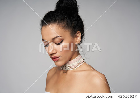 Beauty profile portrait of beautiful mixed race woman wearing chocker Beauty profile portrait of beautiful mixed race woman wearing chocker 42010627