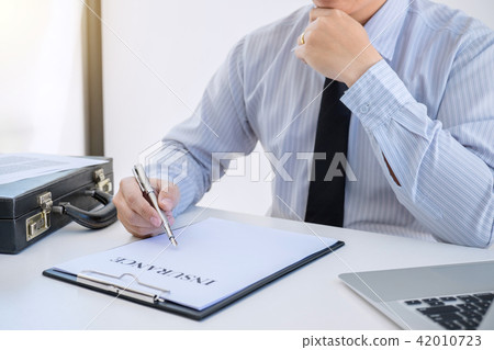 Insurance concept, businessman signing a car insurance policy 42010723