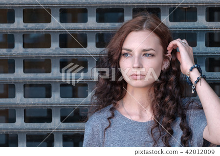 Young girl in front of metal cage 42012009