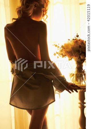 Sensual blonde at the window 42015119