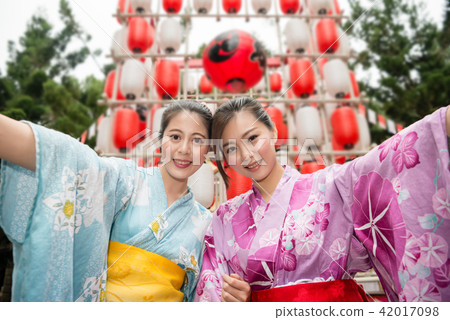 Asian young ladies holding hands together Asian young ladies holding hands together 42017098