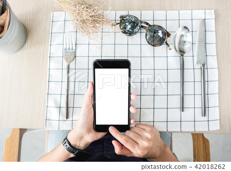 woman use mobile phone apps at restaurant table woman use mobile phone apps at restaurant table 42018262