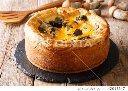 Freshly baked pie, quiche with boletus mushrooms 42018647
