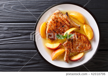 grilled pork chop with glazed peaches and honey grilled pork chop with glazed peaches and honey 42018706
