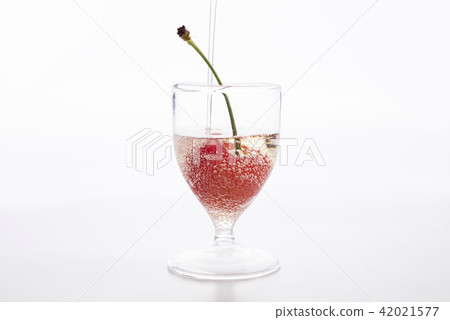 用櫻桃將碳酸鹽倒入迷你玻璃杯中 42021577