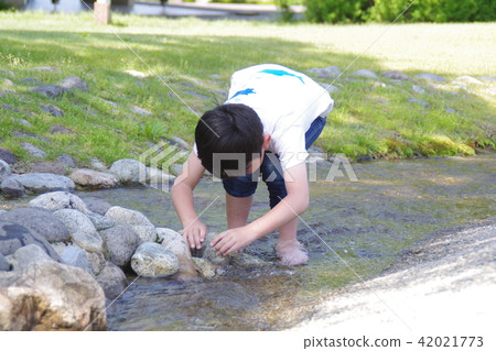 Boys playing in river water Boys playing in river water 42021773
