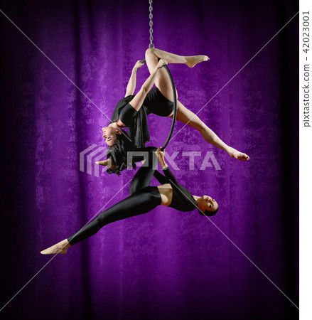 Women doing gymnastic exercises on the ring Women doing gymnastic exercises on the ring 42023001