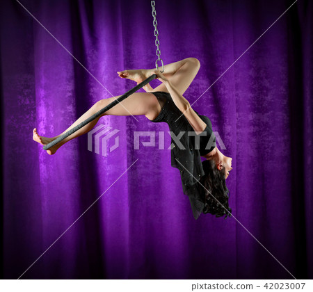 Woman doing gymnastic exercises on the ring Woman doing gymnastic exercises on the ring 42023007