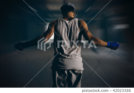 Athlete rides through a rope in the gym Athlete rides through a rope in the gym 42023388