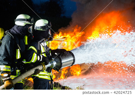 Firefighter - Firemen extinguishing a large blaze 42024725
