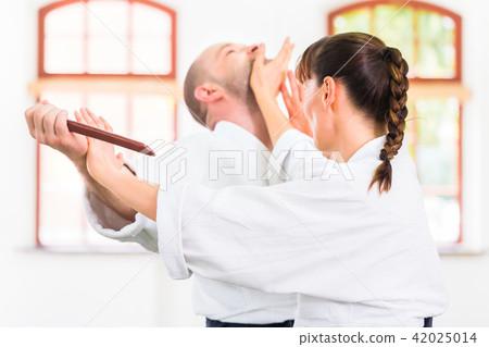 Man and woman having Aikido knife fight Man and woman having Aikido knife fight 42025014