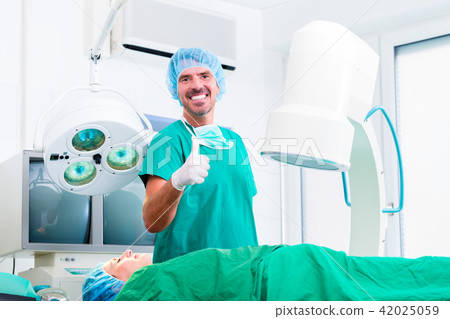 Doctor having successful operation in operating room 42025059