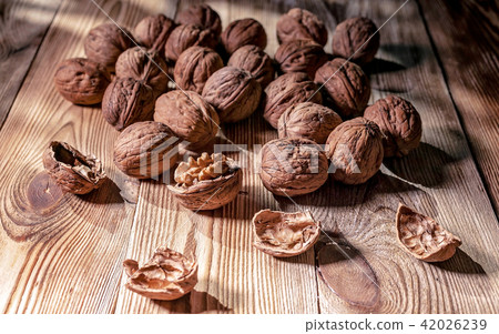Walnuts on a wooden table. 42026239