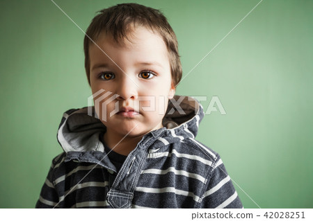 gloomy cute child boy holding hands in pockets 42028251