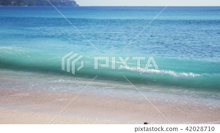 Ocean seascape scenic with large wave crashing on sandy shore. Bali Ocean seascape scenic with large wave crashing on sandy shore. Bali 42028710