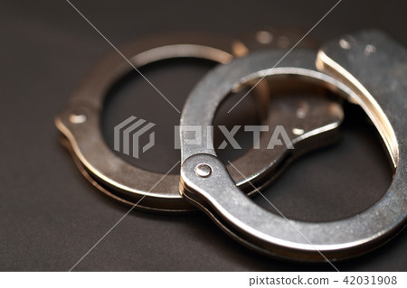 Handcuffs (accident arrested capture black black dark security bad fraud restrained locking) Handcuffs (accident arrested capture black black dark security bad fraud restrained locking) 42031908