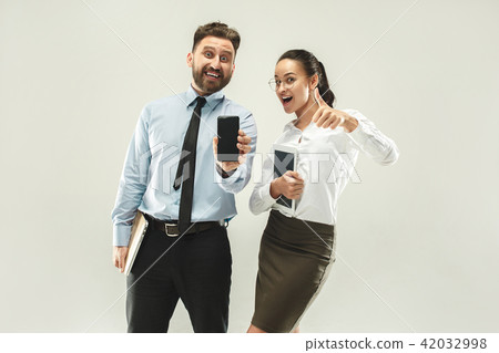 a business man shows the laptop to his colleague in the office. 42032998